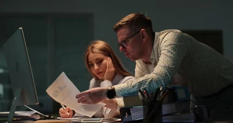 Colleagues review document and plan next step near computer Stock Footage 318322889