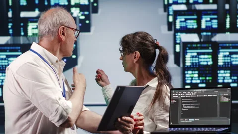 Colleagues running code in data center Stock Footage 249969825