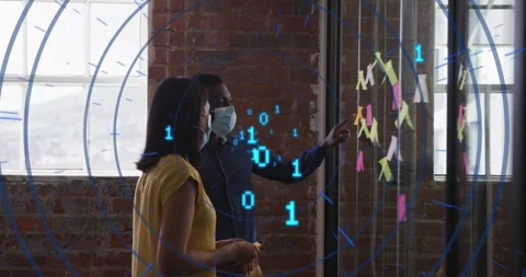 Colleagues selecting notes, building grid on glass wall with binary code 動画素材 318046284