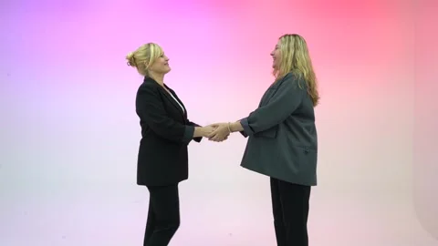 Colleagues shake hands in a friendly manner, smiling warmly. Business handshake Stock Footage 301525417