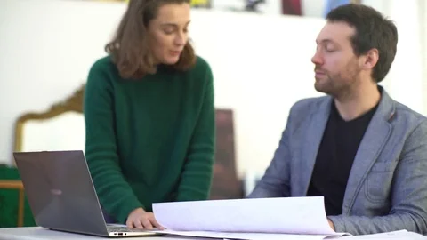 Colleagues shaking hands while collaborating in office Stock Footage 75182313