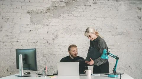 Colleagues Sharing Work in an Office Stock Photos