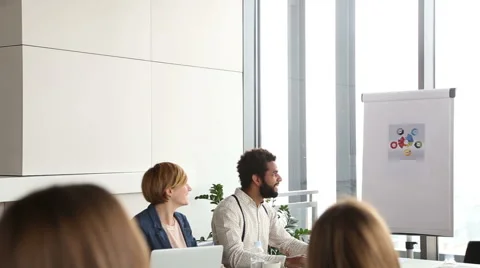 Colleagues smiling while their female colleague giving presentation Stock Footage 59544310