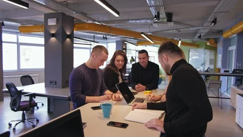 Colleagues smiling while working in the office meeting Stock Footage 94833205