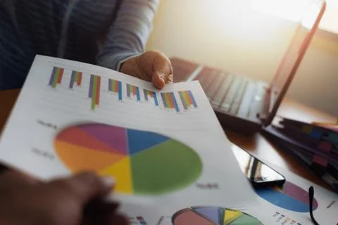 Colleagues submitted trade data chart document to each other. Stock Photos