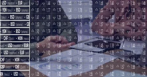 Colleagues in suits analyzing forex data at trading desk, using laptop Stock Photos