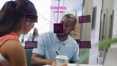 Colleagues at table, square appearing over man expanding into control HUD grid Stock Footage 332667037