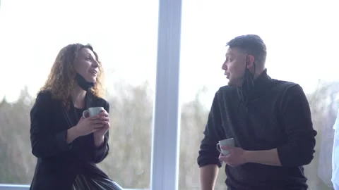 Colleagues talk during break in office kitchen. Curly woman communicates with Stock Footage 167694775