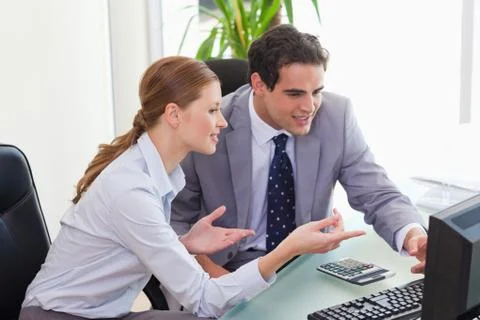 Colleagues talking about computer problems Stock Photos