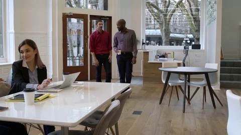Colleagues talking and working in an office 動画素材 77080821