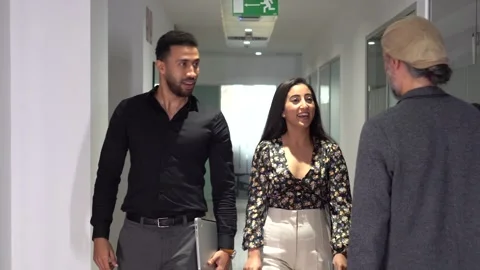 Colleagues talking in the corridor of a co-working Stock Footage 252123305