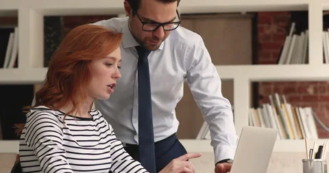 Colleagues talking working on collaborative online project use laptop Stock Footage 150739981