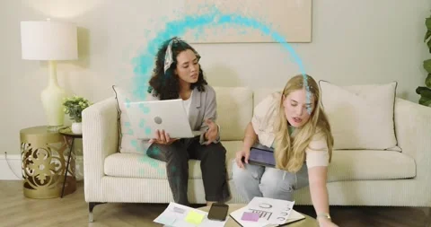 Colleagues tapping laptop exchanging charts as turquoise swirl forming around Stock Footage 320416110