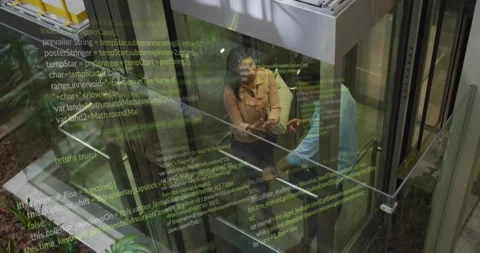 Colleagues tapping smartphone, viewing code overlay in glass elevator and Stock Footage 328354914