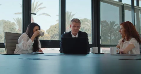 Colleagues team discuss a project using a computer at workplace. Stock Footage 139917024