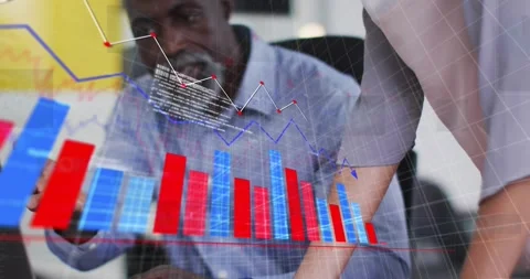 Colleagues typing data, displaying transparent charts overlaying desk and Stock Footage 320287530
