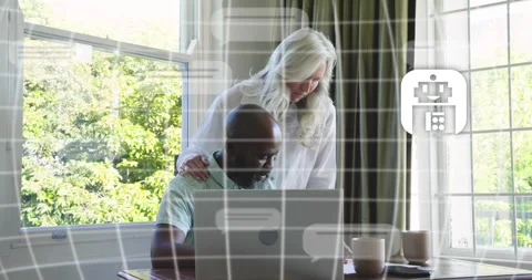 Colleagues typing on laptop as chat bubble prompt triggers robot icon and text Stock Footage 317733610