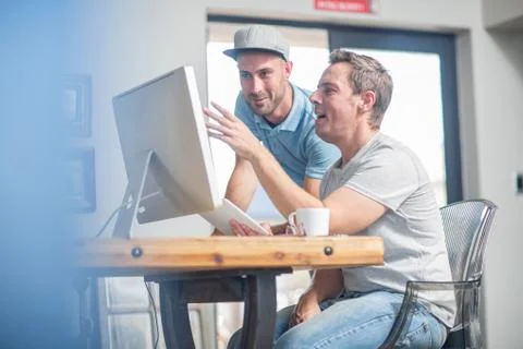 Colleagues using computer Stock Photos