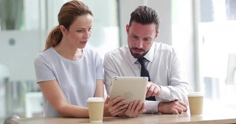 Colleagues using a digital tablet in a meeting Stock Footage 79145214