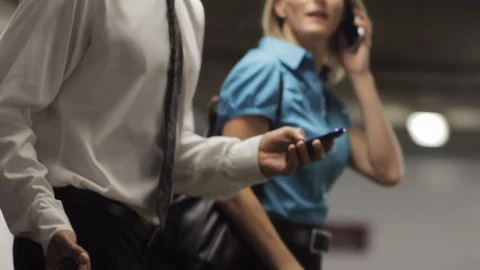 Colleagues using smart phones in a parking lot. Stock Footage 88371049