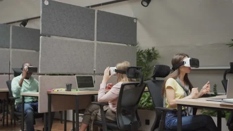 Colleagues in VR helmets discussing project Stock Footage 142540370