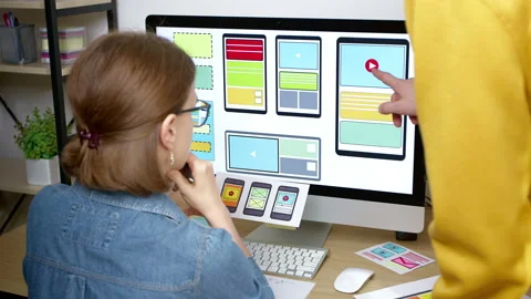 Colleagues web designers are working on the development of an application  Stock Footage 208870737