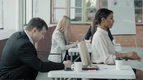 Colleagues work in the office space. A female employee moves in an office chair Stock Footage 124547948