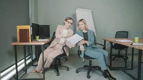 Colleagues work together in office setting with focus on tasks and communication Stock-Footage 326323701
