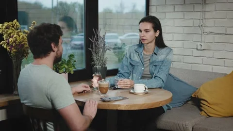 Colleagues from work went to have a bite to eat in a city cafe. A man and a Stock Footage 226579471