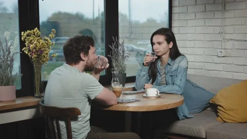 Colleagues from work went to have a bite to eat in a city cafe. A man and a Stock Footage 228664831