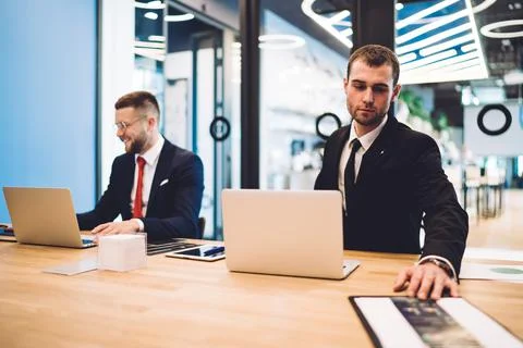 Colleagues working and using gadgets in modern office Stock Photos