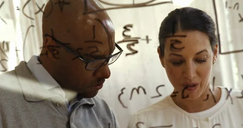 Colleagues working on equations together. Stock Footage 88376553