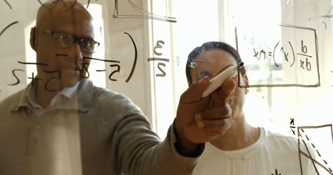 Colleagues working on equations together. 스톡 동영상 88376567