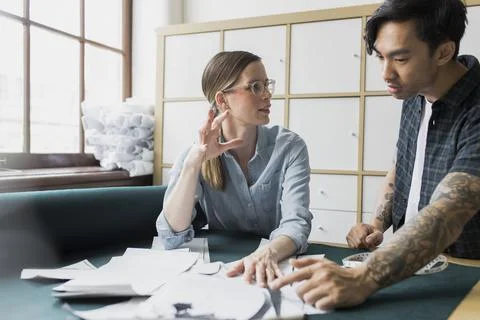 Colleagues working in fabric design studio Stock Photos