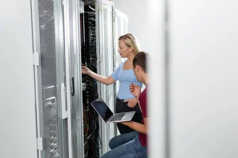 Colleagues working on maintaining a server room. Good enviroment for worki... Stock-Fotos