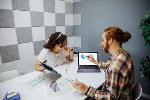 Colleagues working on project using gadgets Stock Photos