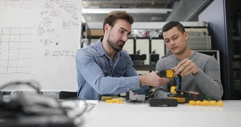 Colleagues working on robotics Stock Footage 86809192