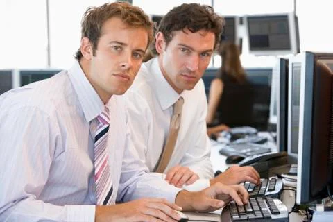 Colleagues Working Together At Computer Stock-Fotos