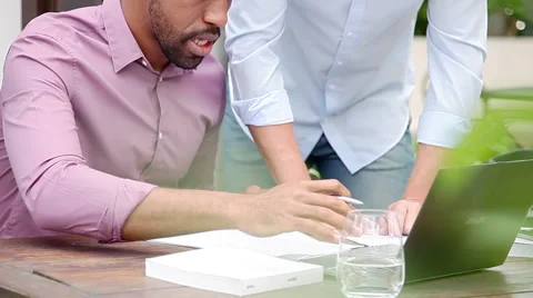 Colleagues working together with laptop computer outdoors Stock Footage 63298850