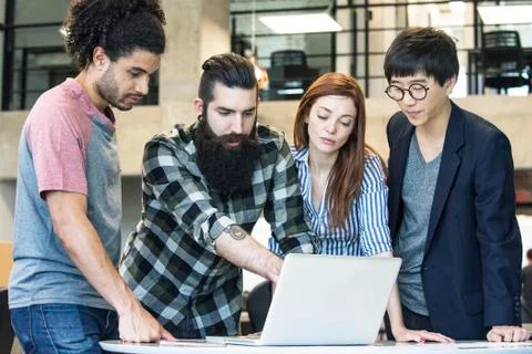 Colleagues working together with laptop computer Stock Photos