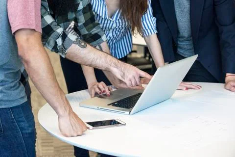 Colleagues working together on laptop computer Stock Photos