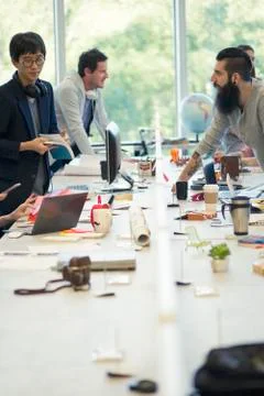 Colleagues working together in open plan office Stock Photos
