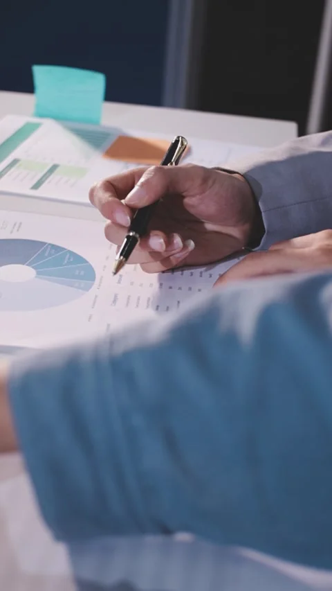 Colleagues working together pointing at business documents during meeting. Stock Footage 344917566