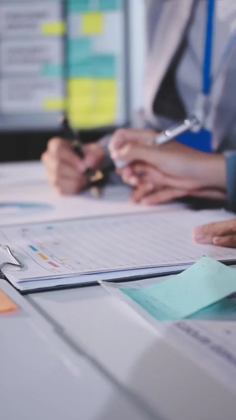 Colleagues working together pointing at business documents during meeting. Stock Footage 344917598