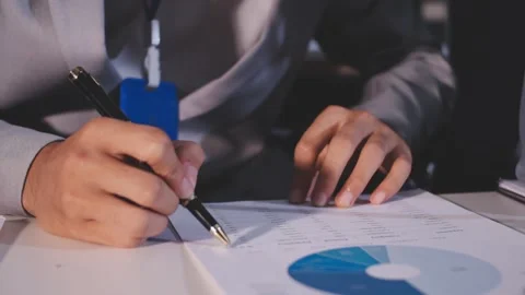 Colleagues working together pointing at business documents during meeting. Stock Footage 344917688