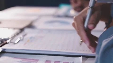 Colleagues working together pointing at business documents during meeting. Stock Footage 344918272