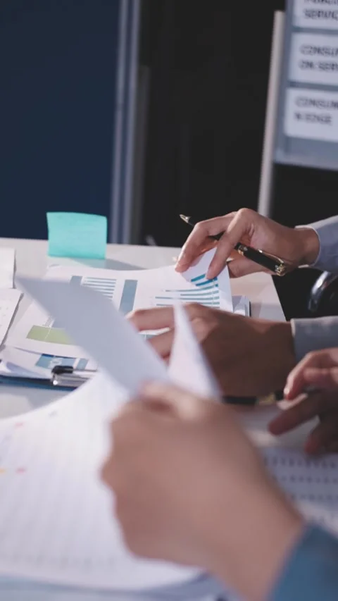 Colleagues working together pointing at business documents during meeting. Stock Footage 344919294