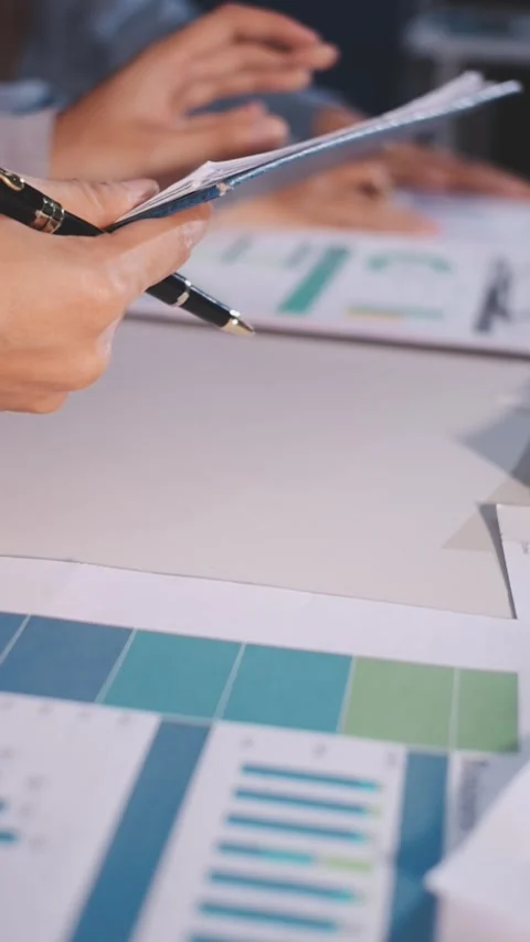 Colleagues working together pointing at business documents during meeting. Stock Footage 344919485
