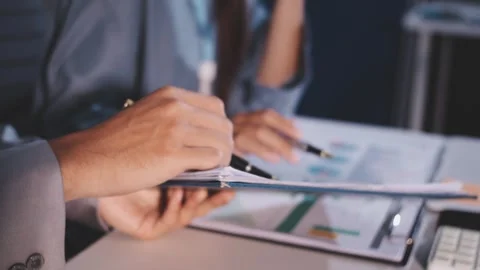 Colleagues working together pointing at business documents during meeting. Stock Footage 344919487