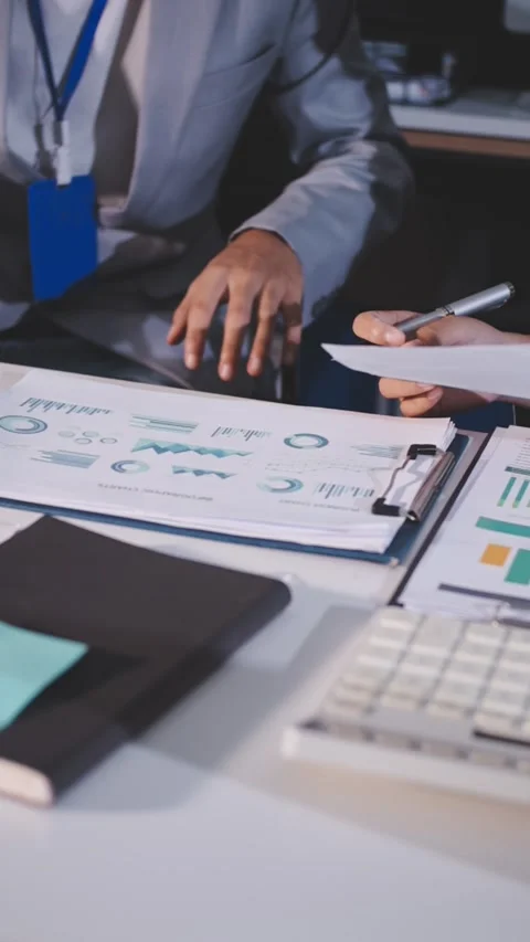 Colleagues working together pointing at business documents during meeting. Stock Footage 344919499
